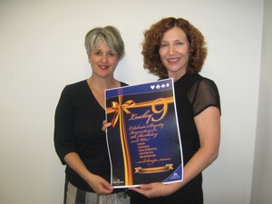 Shirl Glass (one of three original staff members) and Michelle Baillie with a menu of special birthday deals
